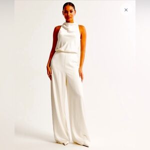 NWT, never worn, white high neck draped jumpsuit. Size M.